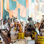 An artist's studio featuring paint brushes found at Art Factory.